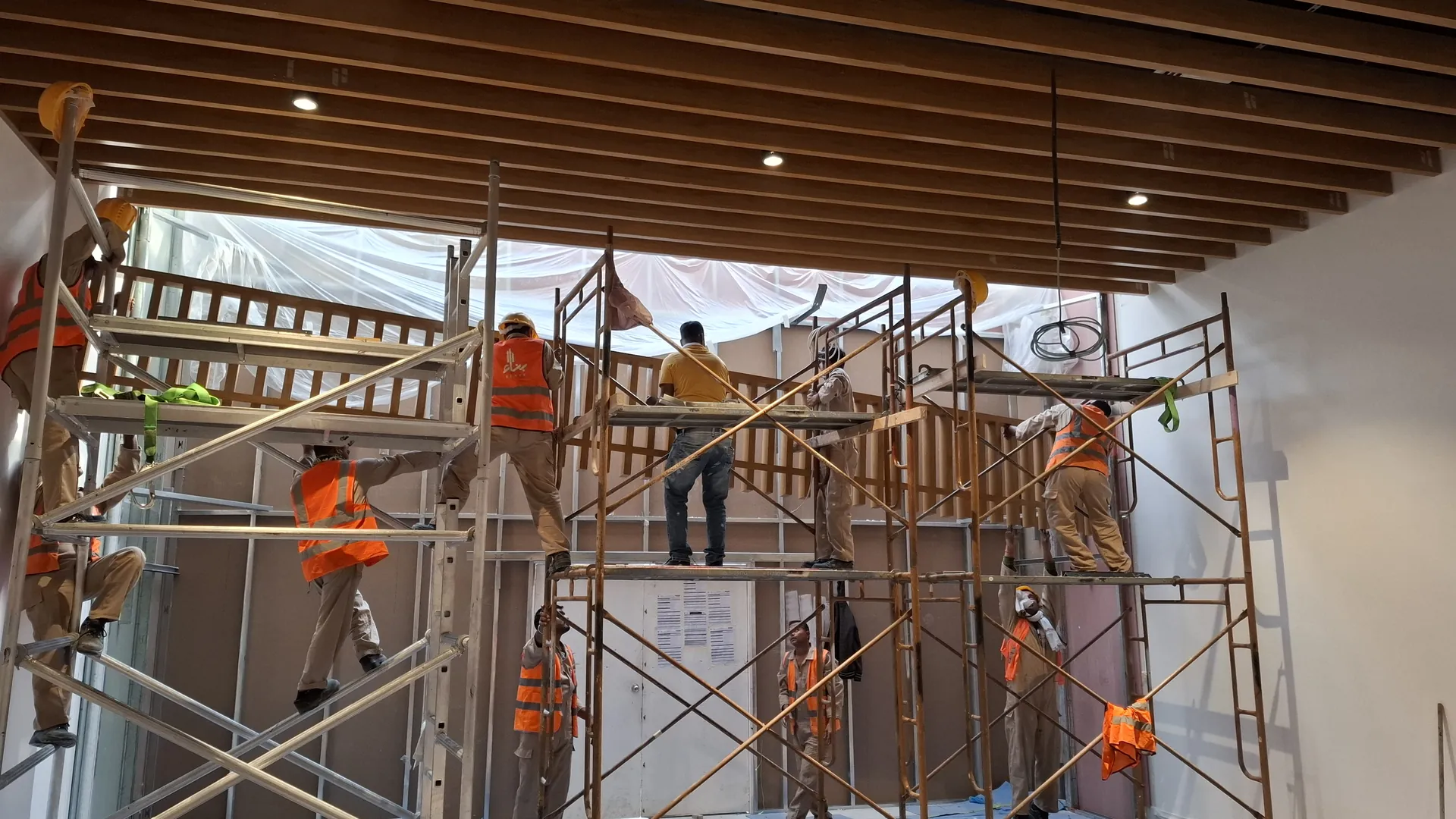 Benaa Contracting crew installing a decorative ceiling during a shopping mall fit-out